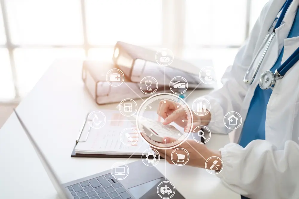 A healthcare professional in a lab coat using a calculator at a desk, surrounded by a digital overlay of medical and financial icons including a stethoscope, ambulance, and credit card.